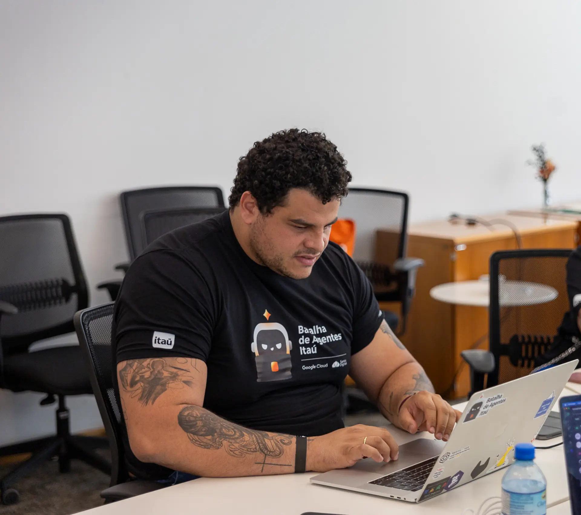 Danilo Marcello trabalhando no notebook na Batalha de Agentes do Itaú